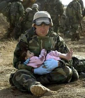 iraq-soldierHoldingIraqiChild.jpg
